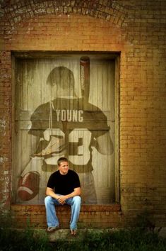 a young man sitting in front of a door with the number twenty on it's side