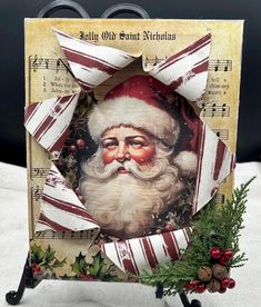 an old fashioned christmas card with santa claus on it and holly wreaths around the edges