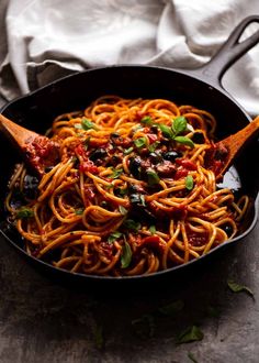 a skillet filled with spaghetti and sauce