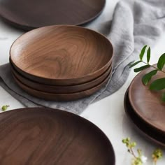 several wooden plates are stacked on top of each other