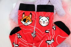 These Hualian mid-calf length socks are inspired bhy the danmei series 'Heaven's Official Blessing' (Tian Guan Ci Fu) and feature the animal forms of both Hua Cheng and Xie Lian. The material is knitted, and will fit adult shoe sizes 3-9 UK women's. Trendy Red Socks As A Gift, Trendy Red Socks As Gift, Trendy Red Socks For Gifts, Trendy Red Socks For Gift, Red Novelty Socks For Winter, Harajuku Style Socks For Winter Stocking Stuffers, Novelty Red Socks For Winter, Cute Red Socks For Gifts, Playful Red Socks For Winter