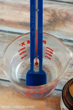 a measuring cup filled with brown sugar next to an empty measuring cup on top of a wooden table