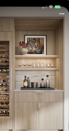 a kitchen with wooden cabinets and wine glasses on the counter top in front of it