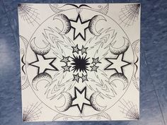 a black and white drawing of an intricate design on a blue marble background with lines in the middle