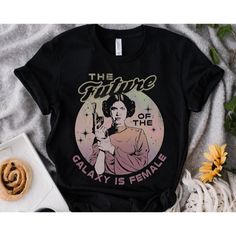 the future galaxy is female t - shirt on a table with flowers and other items