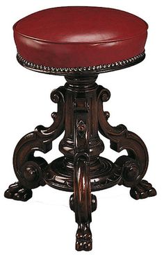 a wooden stool with a red leather cushion on it's seat and foot rest