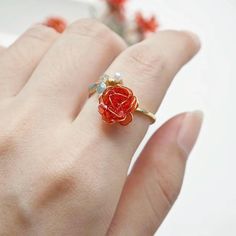 This is a handmade rose-themed ring. Each ring is unique, ensuring that each piece is high quality and exquisite details. This ring can be worn not only for special occasions, but also for daily wear, allowing you to show your unique charm. Size: Adjustable Ring This elegant handmade rose ring is the perfect addition to your jewelry collection. It features a bright red rose carefully crafted from a translucent resin-like material, set on a polished gold-tone adjustable band. Accented with charming details such as tiny pearls and delicate floral decorations, this piece is both whimsical and sophisticated. Whether it is a thoughtful gift for a loved one or a personal statement piece, this ring will easily elevate any outfit. Perfect for special occasions or daily wear, it is sure to attract Accessories Pearl, Fairy Ring, Handmade Rose, Floral Decorations, Colorful Roses, Rose Ring, Rose Rouge, Jewelry For Her, Christmas Gifts For Women