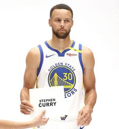 the golden state warriors'stephen curry signs autographs for fans to sign on his jersey