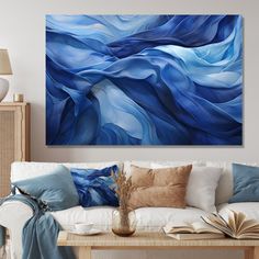 a living room scene with focus on the couch and large blue painting hanging above it