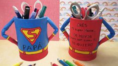 two cups with pencils, pens and scissors in them