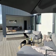 an outdoor living area with couches and tables