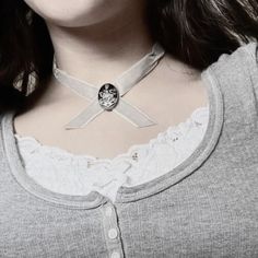 a woman wearing a necklace with a cross on it