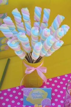 there are candy sticks in a vase on the table