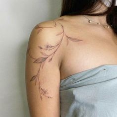 a woman with a tattoo on her shoulder