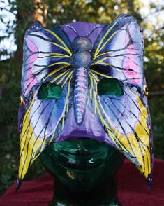 This large mask will be the finishing touch for any butterfly or fairy costume. It can be worn for the Halloween season, on stage for a production, Ren Faire, Fairy Festival or anytime you want to make believe.  The mask can also be worn upside down with the yellow wings up for a different look. The mask is constructed with layers of paper mache on a recycled cardboard base. The design is hand painted with acrylic paint and sealed with a polymer finish. Synthetic cording is laced through metal grommets set into the mask. It can be adjusted with a sliding toggle clasp.  The mask measure approximately 8 inches in height, 6,25 inches in width and .5 inch in depth. Ren Faire Fairy, Butterfly Mask, Fairy Festival, Recycled Cardboard, Make Believe, Costume Mask, Fairy Costume, Halloween Season, Paper Mache