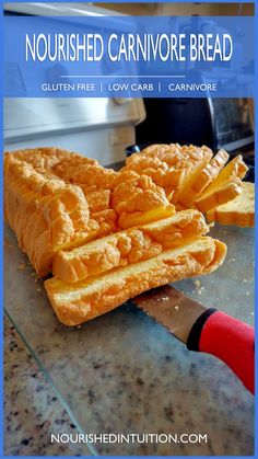 there is a sandwich cut in half on the counter and ready to be eaten with a knife