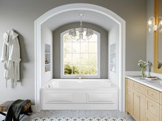 a large white bath tub sitting under a window