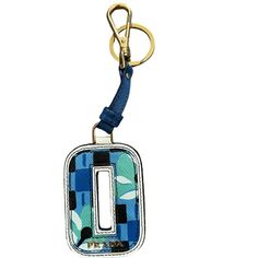 a keychain with a blue and green pattern on it, hanging from a metal hook