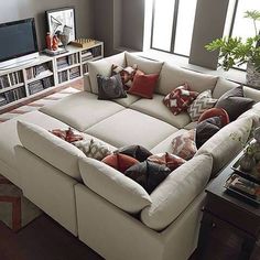 a living room filled with furniture and a flat screen tv mounted on a wall above it