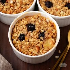 three white bowls filled with oatmeal sitting on top of a wooden table