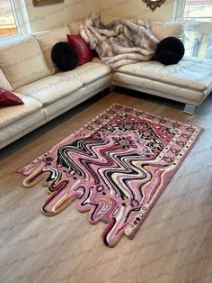 a living room with white couches and pink rug