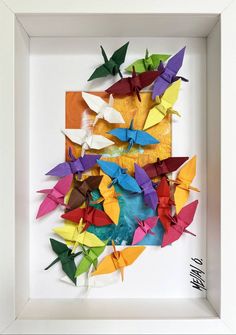 colorful origami birds in a white frame