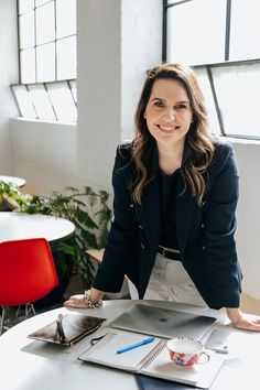 a woman sitting at a table in an office