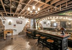 an old fashioned bar with stools and lights