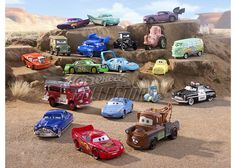 the cars are all lined up on the rocks in front of each other and have different colors