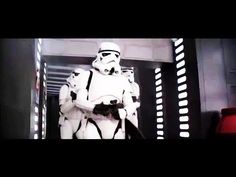 a group of star wars stormtroopers standing in front of a doorway with lights on