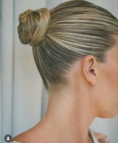 a woman with blonde hair in a bun