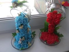 two cakes made to look like flowers are sitting next to each other on a window sill