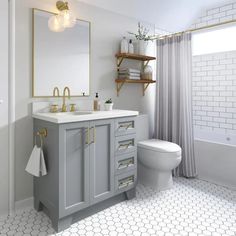 a white and blue bathroom with hexagonal floor tiles on the floor, gold accents