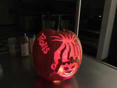 a pumpkin carved to look like a tiger with the word lion on it's face