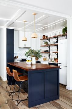 a kitchen with blue cabinets and wooden floors