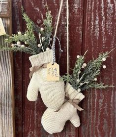 a teddy bear hanging on the side of a wooden door with a tag attached to it