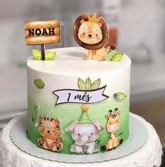 a birthday cake decorated with animals and nameplates