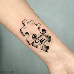 a person's arm with a piece of puzzle on it and the word me written in black ink