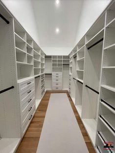 an empty walk - in closet with lots of white shelving and drawers on the walls