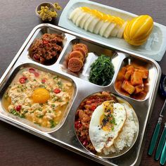 a metal tray filled with different types of food