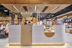 the inside of a restaurant with people sitting at tables