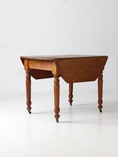 an old wooden desk with two legs and a small table top on one end, against a white background