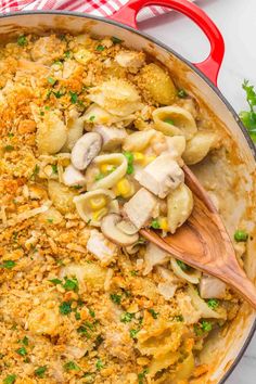 creamy turkey casserole in a pan with wooden spoon and parsley on the side