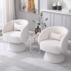 two white chairs and a table in a room