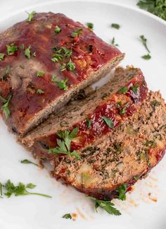 sliced meatloaf on a plate with parsley sprinkled around the edges