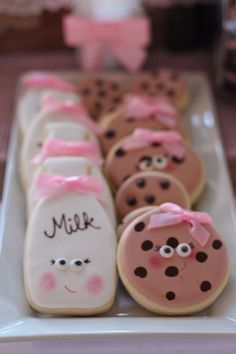 some cookies are decorated with pink and black polka dots on the top one has a cookie in the shape of a lady's face