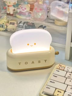 a toy toaster sitting on top of a desk next to a calculator