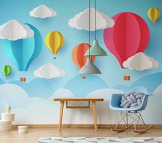 colorful hot air balloons floating in the sky on a blue and white wallpapered room