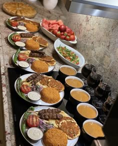 several plates of food are lined up on the counter