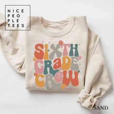 a sweater with the words sixth grade crew printed on it